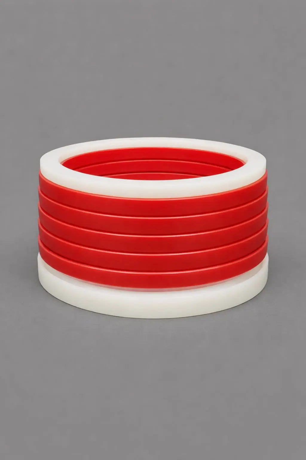 Chevron pack (vee packing set) in red polyurethane and white PTFE adaptor rings for high-pressure hydraulic cylinder rod and piston sealing.