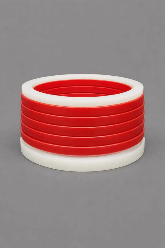 Chevron pack (vee packing set) in red polyurethane and white PTFE adaptor rings for high-pressure hydraulic cylinder rod and piston sealing.