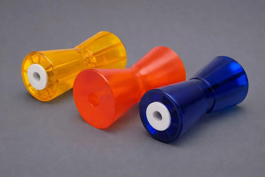 Custom polymer boat rollers for marine trailers – yellow, orange and blue polyurethane keel/wobble rollers with white centre bushes on a grey background.