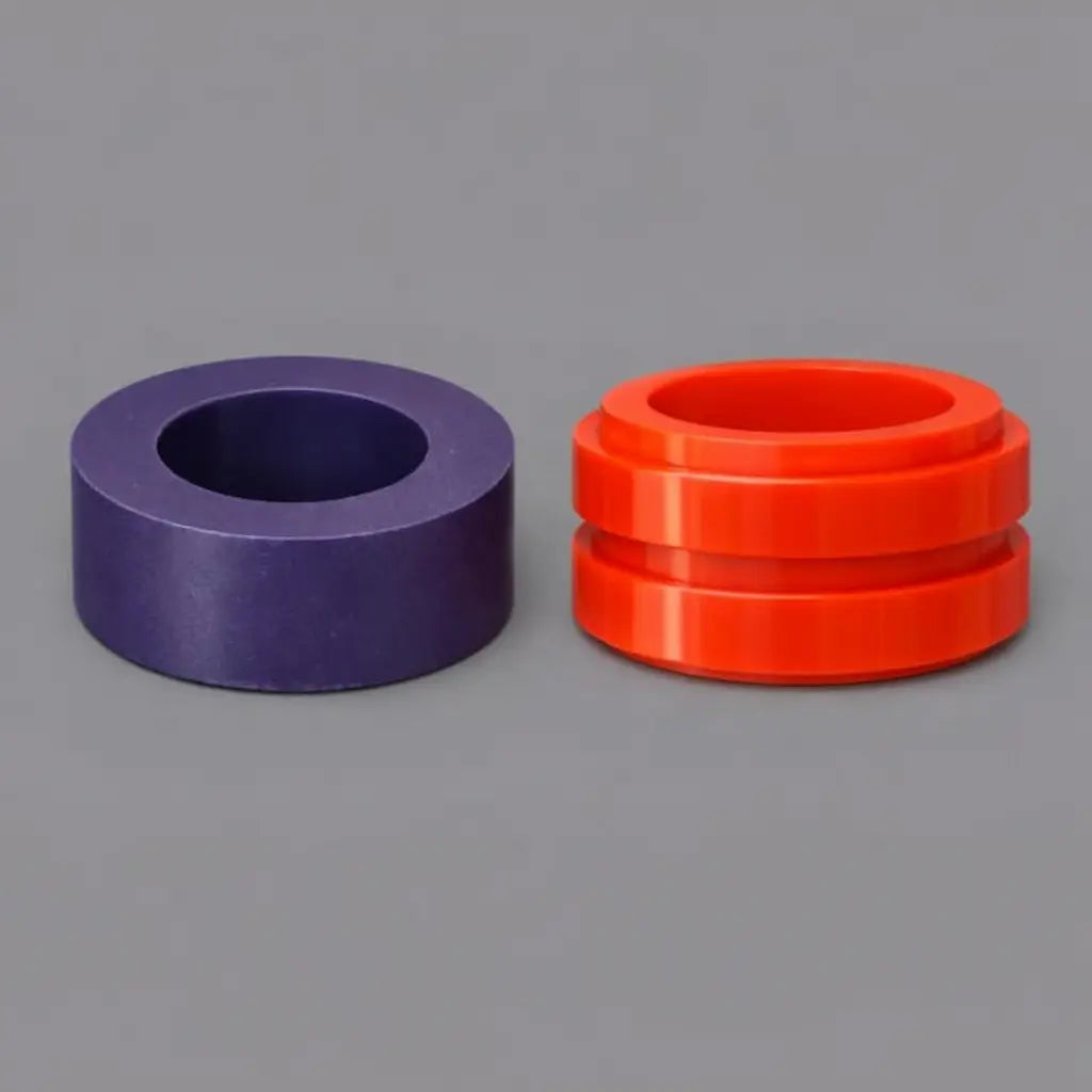 Purple and red polyurethane bushes and bushings for industrial vibration isolation and heavy-duty pivot support on grey background.