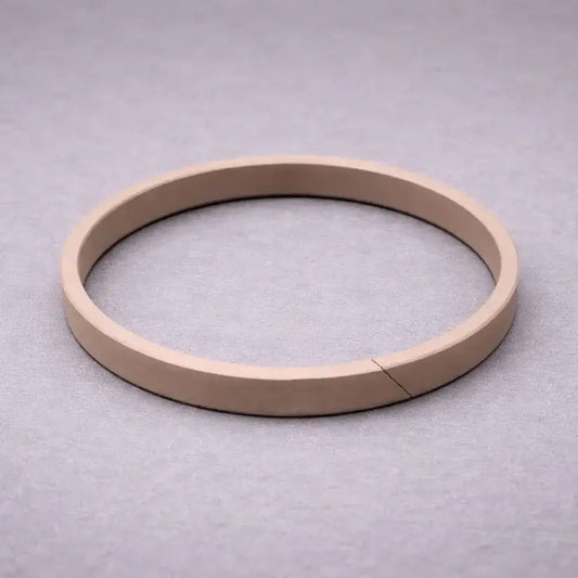 Split wear band (guide ring) for hydraulic and pneumatic cylinder piston guidance, preventing metal-to-metal contact and bore scoring in industrial applications.